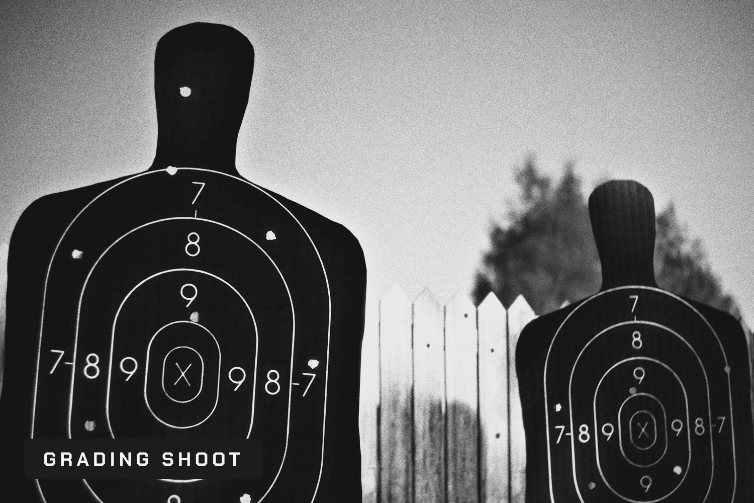 Two shooting range silhouette targets with bullet holes